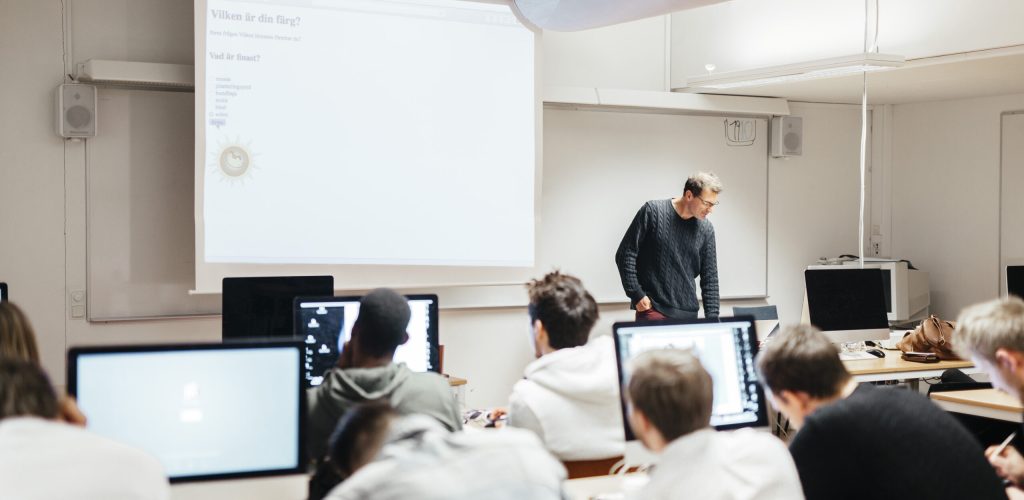 Media students and teacher in classroom